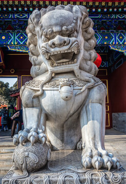 Traditional figure of imperial guardian lion next to gate of Jingshan Park in Beijing city, China