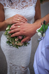 newlyweds, close-up hands with rings, joined together, hold hands
