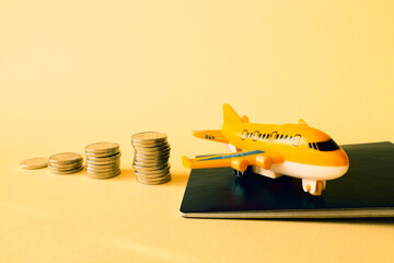 Piles of coins are laid out in increasing number of coins in a stack on a yellow background and an...
