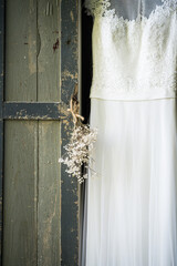 Gypsophila with vintage window shutter and wedding dress for window
