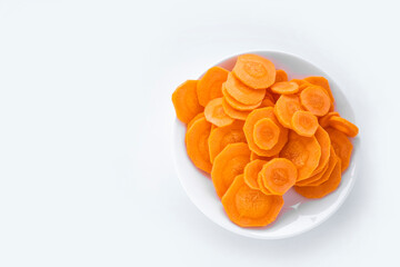 Carrot slices on a small white plate on a white background
