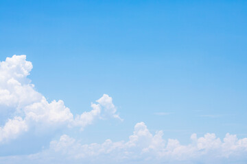 Blue sky background and white clouds soft focus, and copy space
