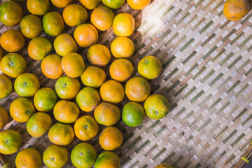Tangerine orange in Thai hand-crafted tray. Top view