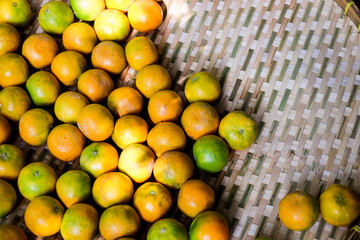 Tangerine orange in Thai hand-crafted tray. Top view