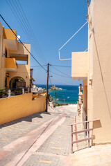 Houses on the street against the sea