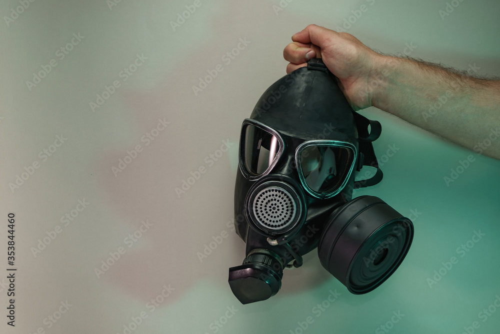 Aufkleber hand hold black old gas mask in the color light. beautiful old minimal in neon light. minimalism ret