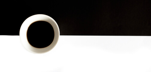 outline of a steaming coffee cup on black and white background