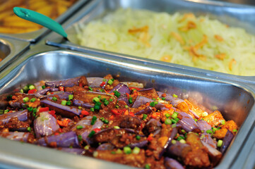 Steel tray filled with food inside the self service Chinese restaurant