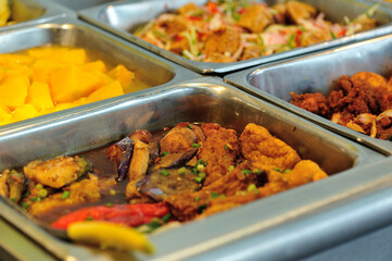 Steel tray filled with food inside the self service Chinese restaurant