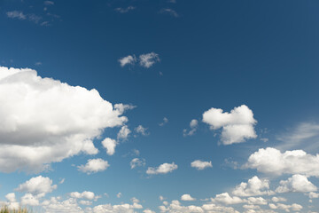 Naklejka na ściany i meble white cumulus clouds on a blue sky. Place for text