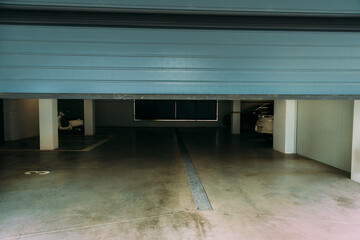 Photo of an automatic closing blue pvc door of a garage with a remote controller