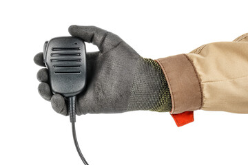 Man hand in black protective glove and brown uniform holding walkie talkie handheld microphone...
