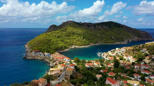 Assos village in Kefalonia, Greece. Turquoise colored bay in Mediterranean sea with beautiful colorful houses in Assos village in Kefalonia, Greece, Ionian island, Cephalonia, Assos village.