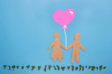 Paper couple with a balloon