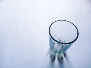 ampati transparent glass tumbler on plane background having space