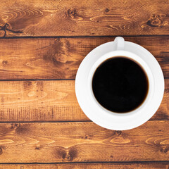 Closeup coffee cup on dark wooden background with copy space and morning sunlight, black coffee in the morning concept
