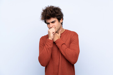 Young caucasian man over isolated blue background is suffering with cough and feeling bad