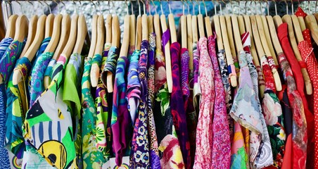 Beautiful colourful dresses hanging on rack