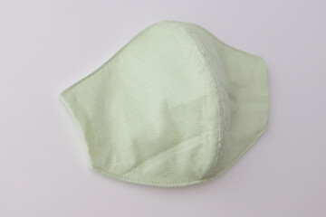 green cloth mask design made from cotton fabric, object on white background