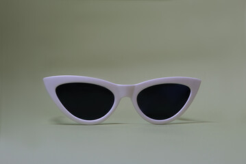 white sunglasses on a light green background