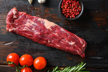 Machete steak raw alternative beef  cut  or hanging tende cut, with rosemary over wood background...