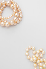 White pearls on the gray background, isolated. Abstract fashion background.