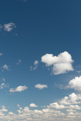 white cumulus clouds on a blue sky. Place for text