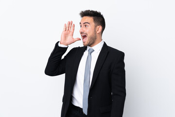 Young business man over isolated background shouting with mouth wide open