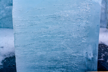 Thick piece of ice with a melting structure. Bubbles of air and thin long strings of melted ice....