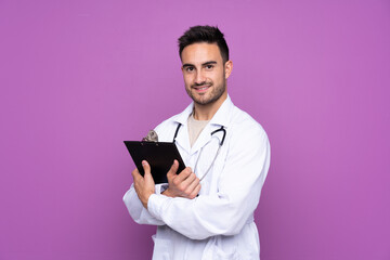 Young man wearing a doctor gown and holding a folder