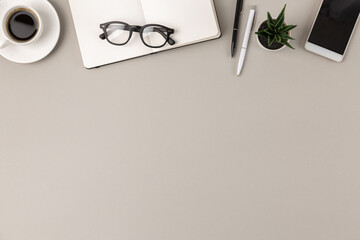 Flat lay border of office supplies on empty modern gray desk with copy space