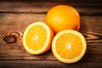 Fresh oranges on old wooden table.