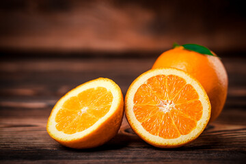 Fresh oranges on old wooden table.