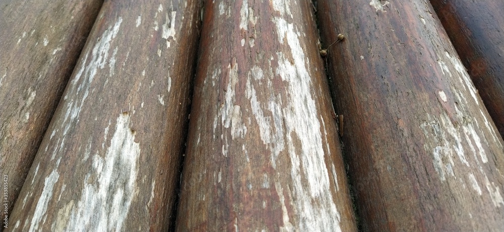 Poster round timber assortment. fragment of the construction of rounded wooden logs. the effect of moisture