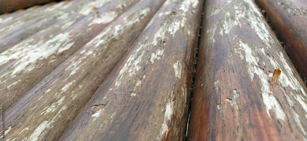 Poster round timber assortment. fragment of the construction of rounded wooden logs. the effect of moisture