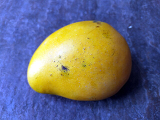 fresh sweet yellow mango isolated on stone background