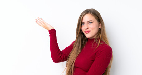Teenager blonde girl over isolated white background extending hands to the side for inviting to come