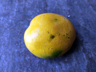 fresh sweet yellow mango isolated on stone background