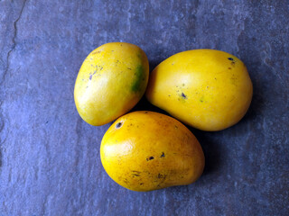 fresh sweet yellow mango isolated on stone background