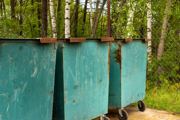 Three old dumpsters in the Park area.