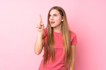 Fototapeta na wymiar Teenager blonde girl over isolated pink background touching on transparent screen