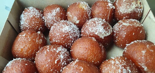 closeup of rusgula gulab jamun with coconut