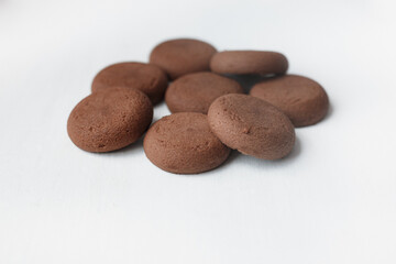 Fototapeta na wymiar Several round brown chocolate cookies on white background top view