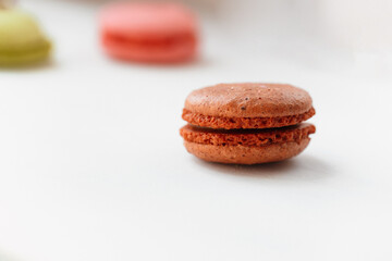 Obraz na płótnie Canvas Brown chocolate macaroon cookie isolated on white background. French gluten free dessert