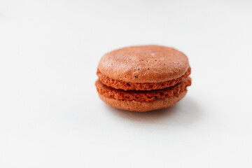 Brown chocolate macaroon cookie isolated on white background. French gluten free dessert