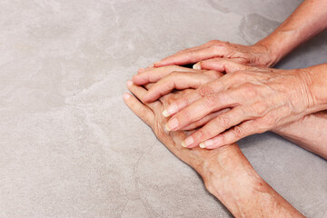 close up image of senior male and female hands over table. Elder couple