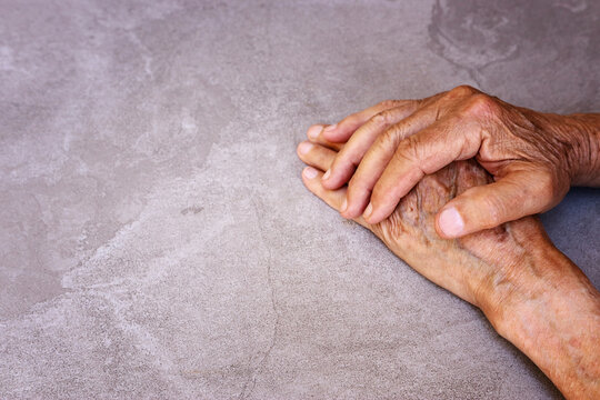 close up image of senior male hands over table