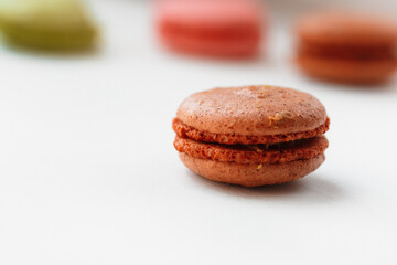 Brown chocolate macaroon cookie isolated on white background. French gluten free dessert