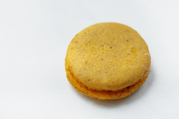 Yellow lemon macaroon cookie isolated on white background. French gluten free dessert