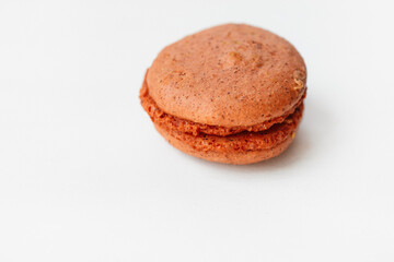 Brown chocolate macaroon cookie isolated on white background. French gluten free dessert